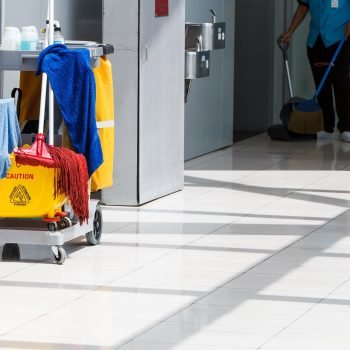 Mop bucket on cleaning in process and worker background