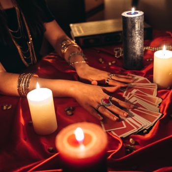 Young female fortune teller reading tarot.