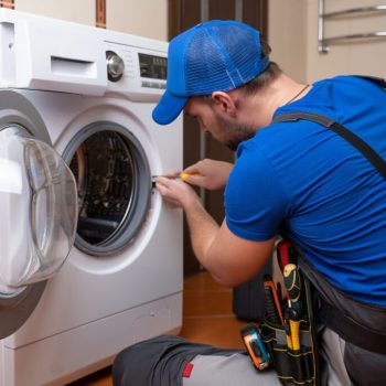 working-man-plumber-repairs-washing-machine-home-washing-machine-installation-repair-plumber-connecting-appliance-1-1-1024x683